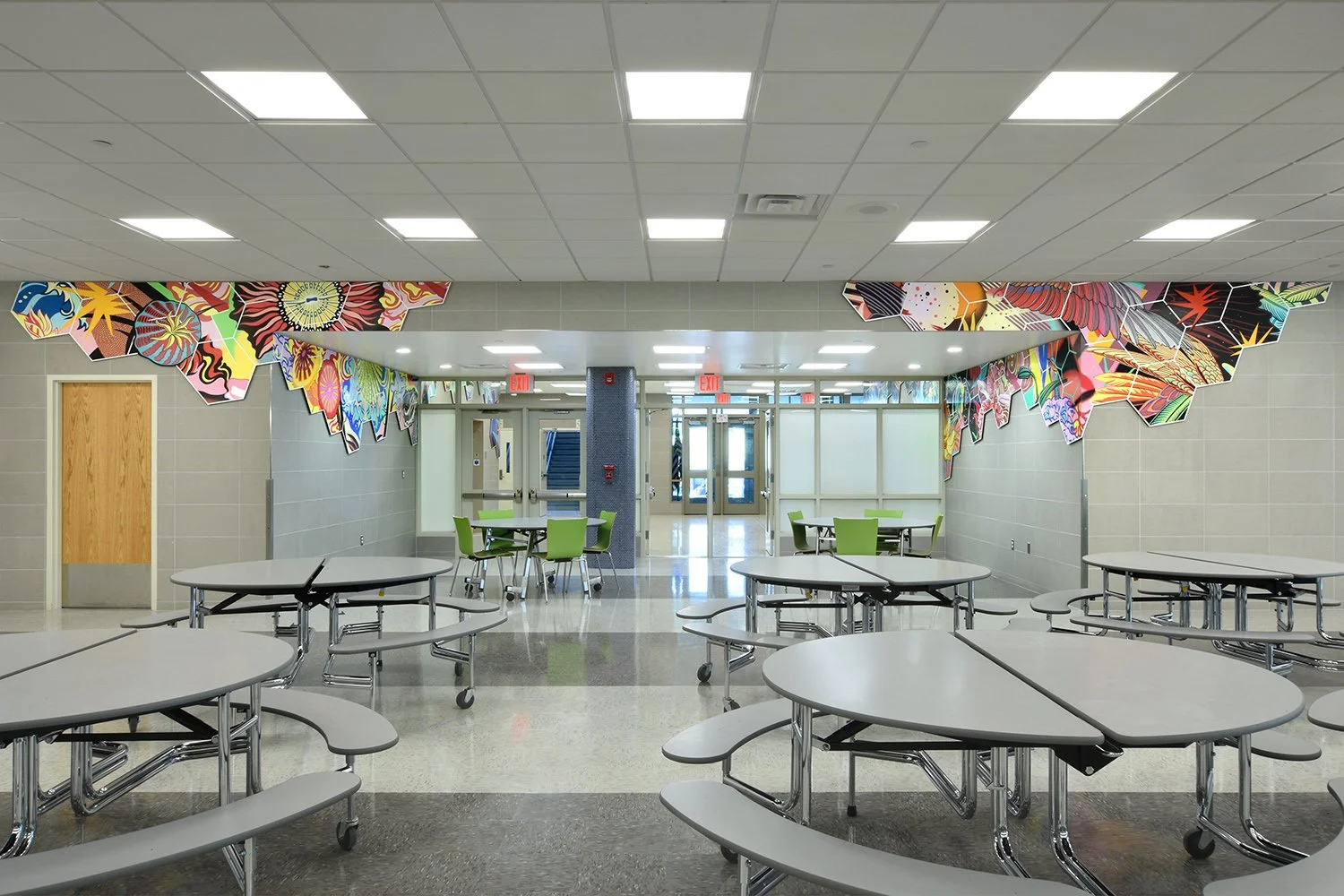 COSMIC BRIDGE - Cafeteria overall perspective looking back toward lobby entrance. Acrylic on shaped dibond panel. Project Description