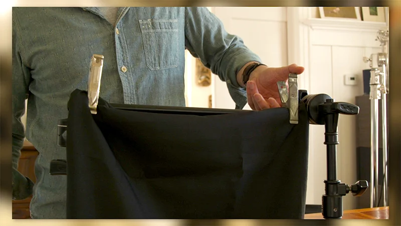 Hanging duvateen off a grip arm to block reflections in glass.