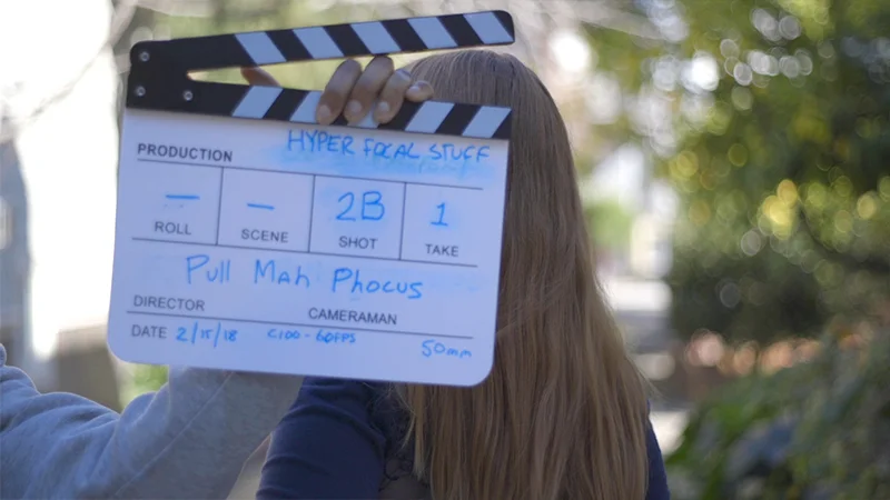 Traditional clapper slate with shot and camera notes, done Pull My Focus style.