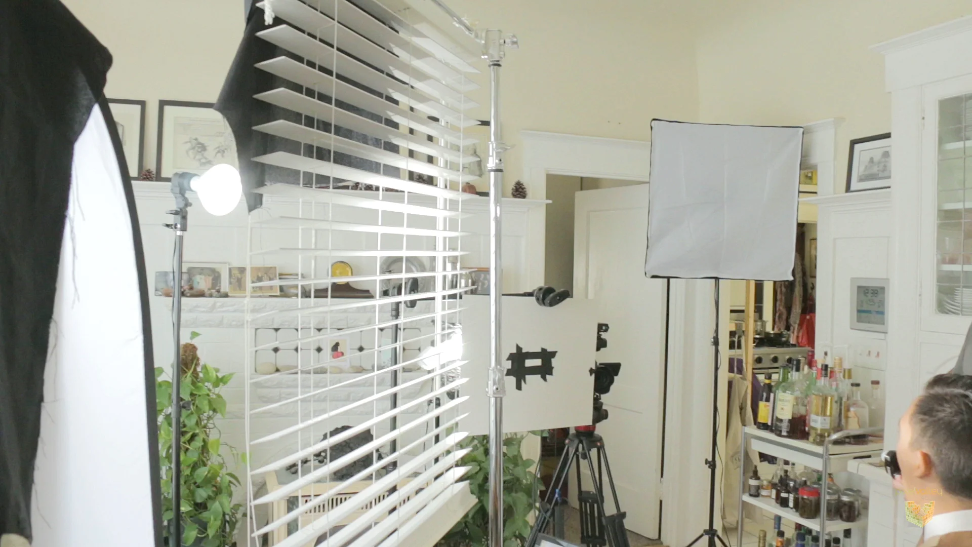 A venetian blind is rigged in front of the key to create shadows on talent and background, a type of cucoloris.