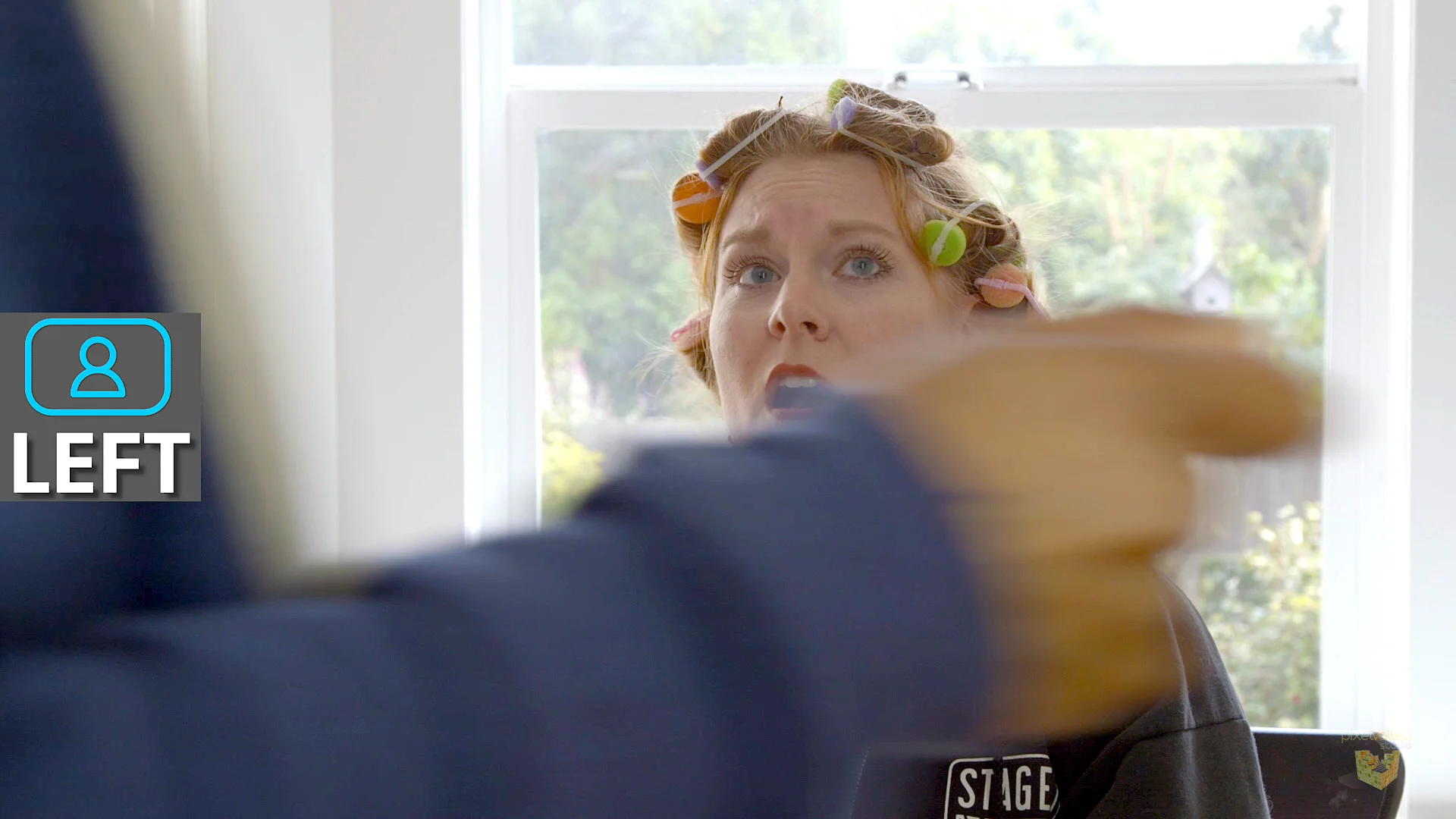 James wipes frame in Courtney's single. Her eyes follow him.