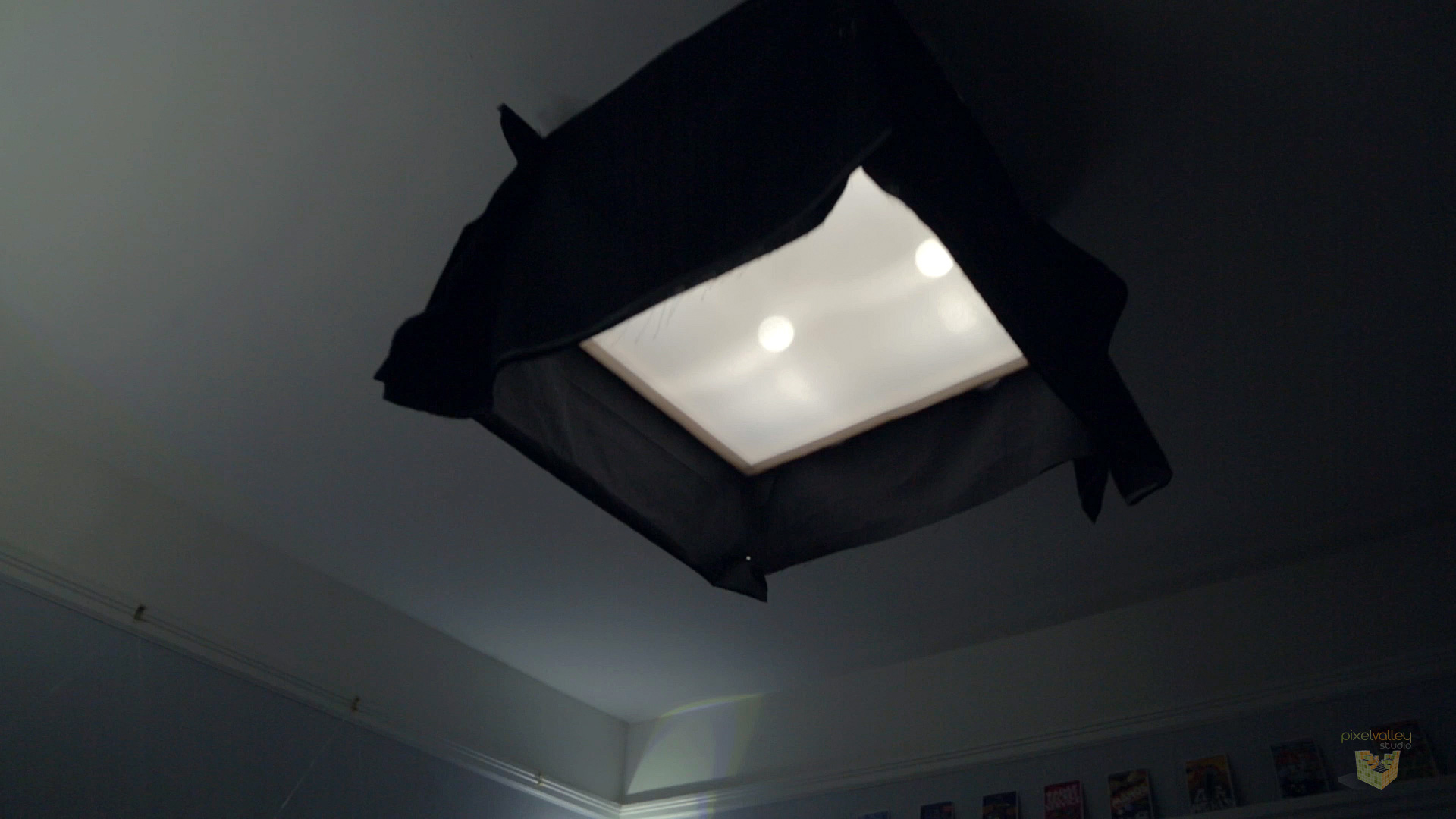 Our box ceiling light with showcard sides and a duvetyne skirt to focus a soft beam of light straight down.
