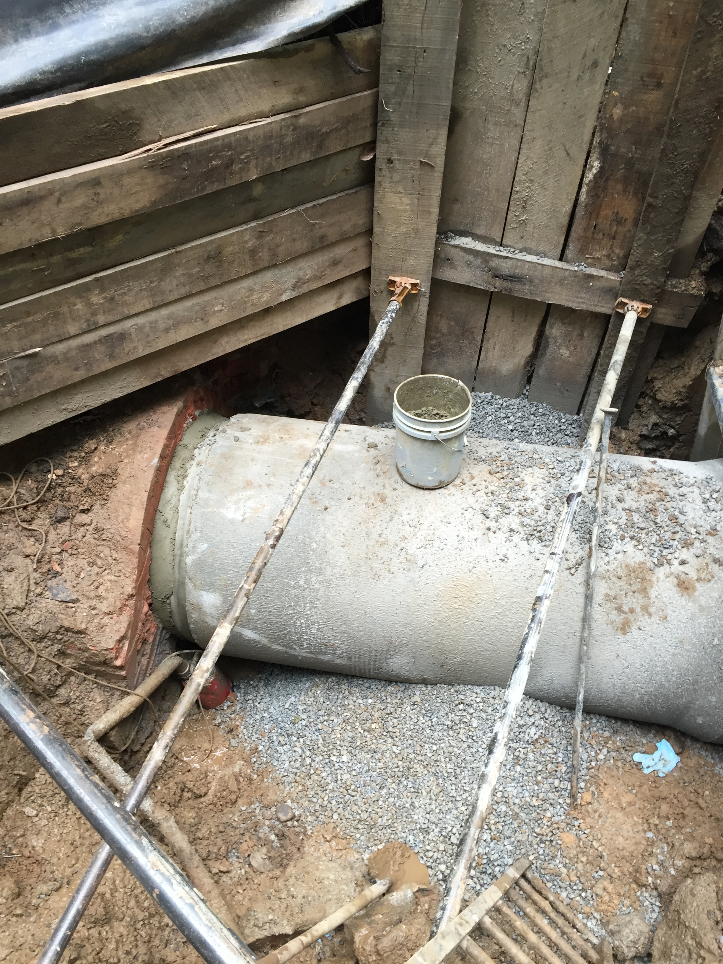 The new concrete pipe is placed against the brick culvert and sealed