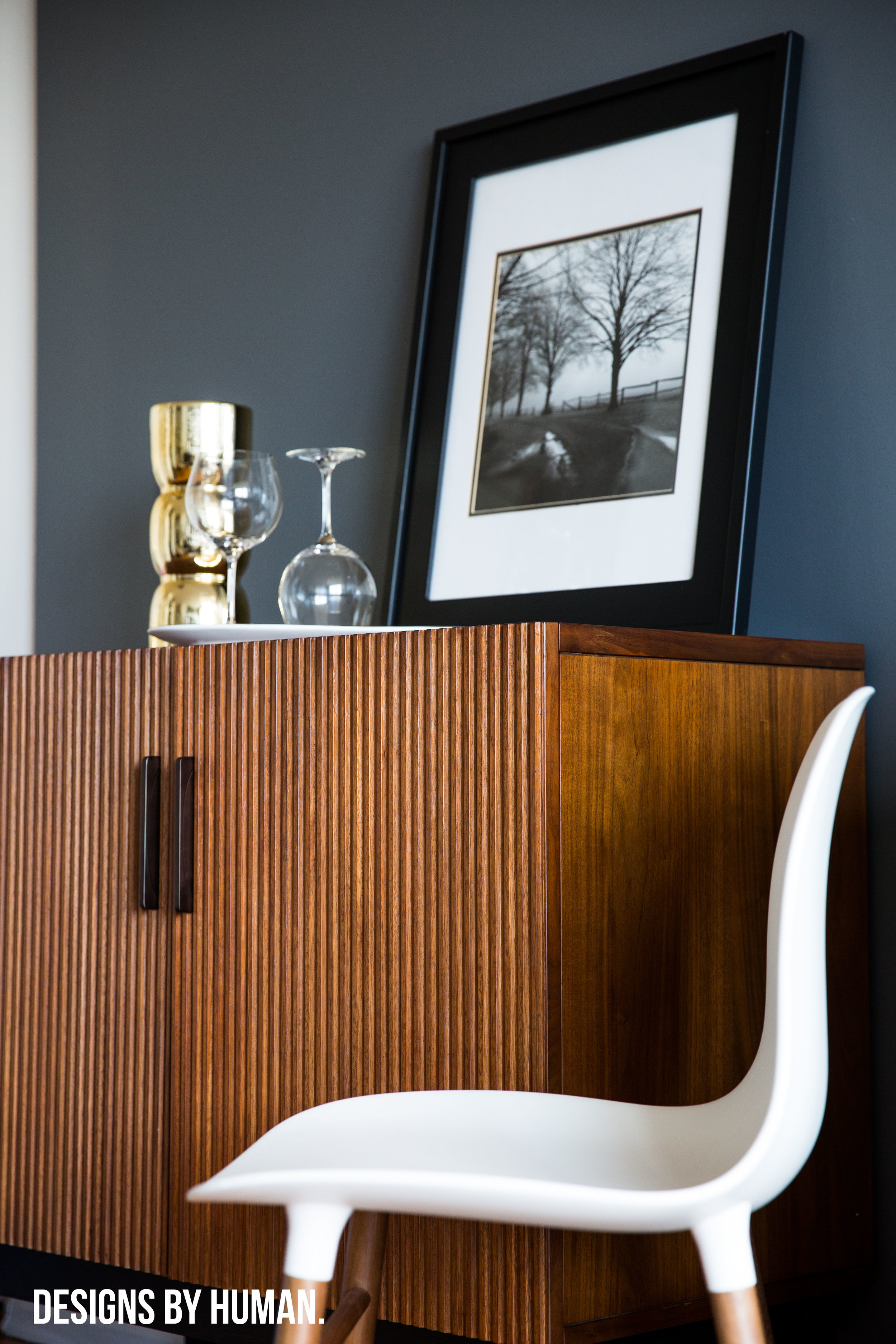 Bar Area - Feng Apartment by Designs By Human . The dark grey walls actually helped to brighten the space and make it feel larger.