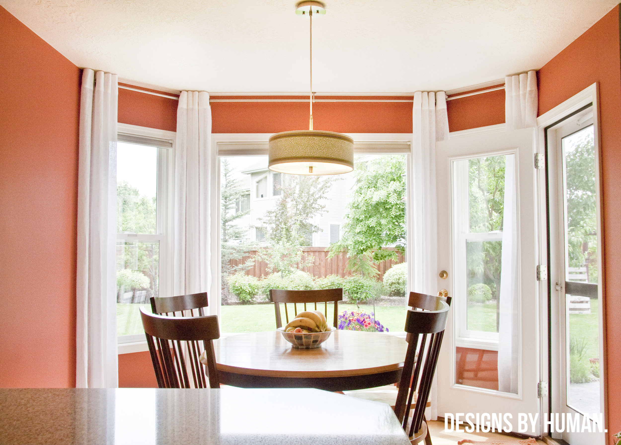 Dining Area - Surprise Valley Residence by Designs By Human . This rich orange is accented with white window trim and treatments. (Check out our recent feature of this project in Elle Decor !!