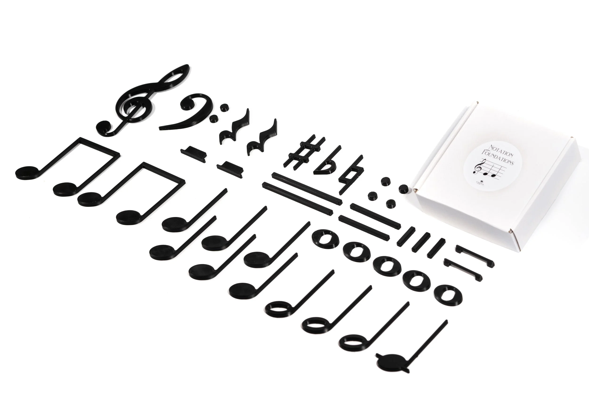 Sound Shapes Notation Foundations magnetic notes, rests and symbols laid out beside a small white box