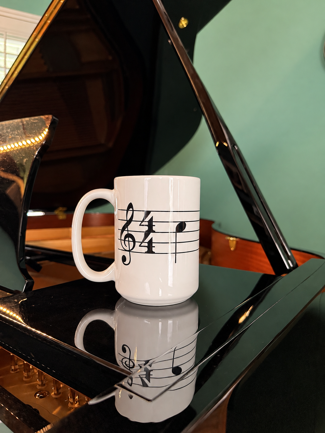 cafe mug on piano.PNG