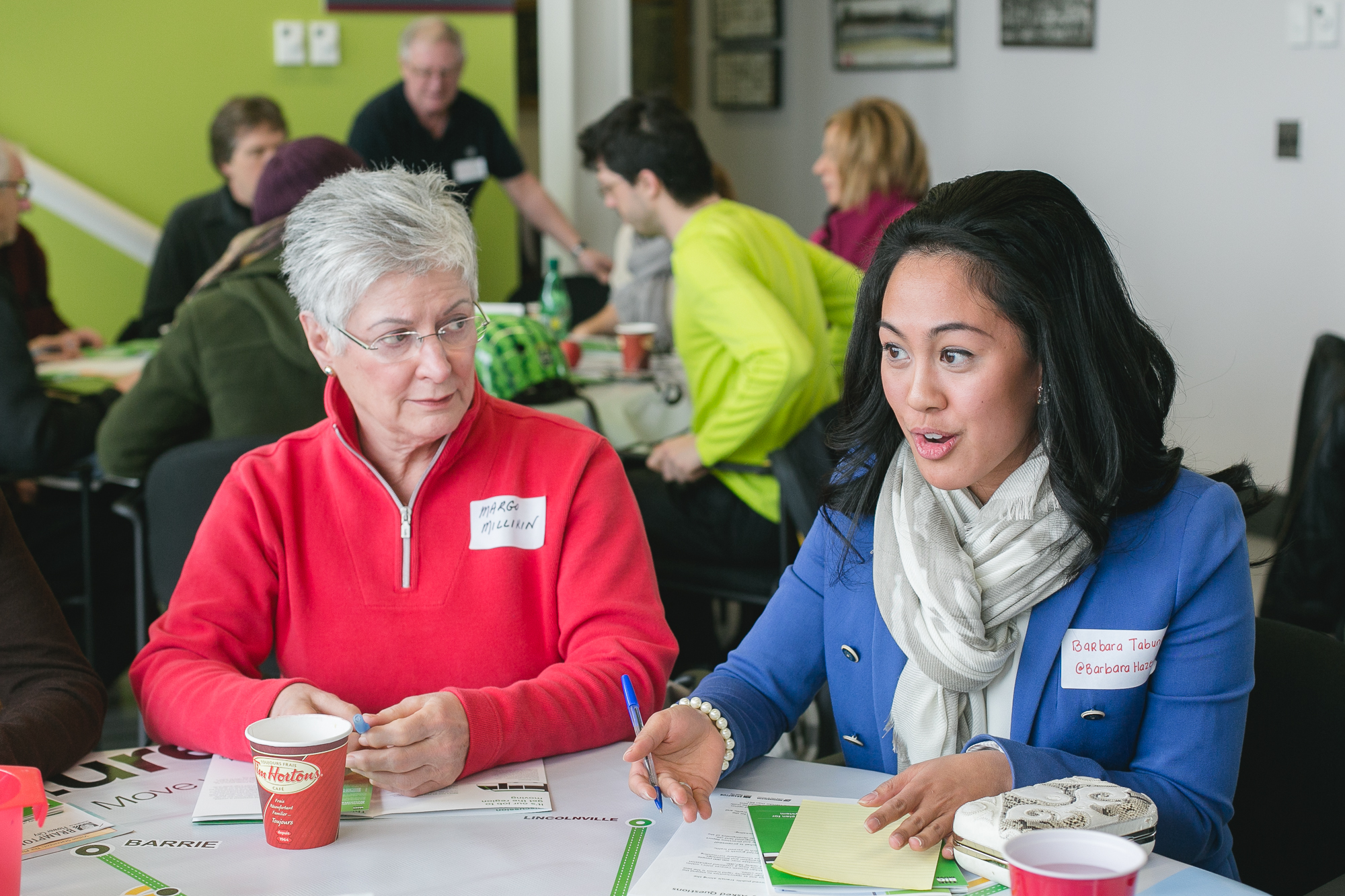 Two participants at the Public Roundtable meetings discuss transit priorities