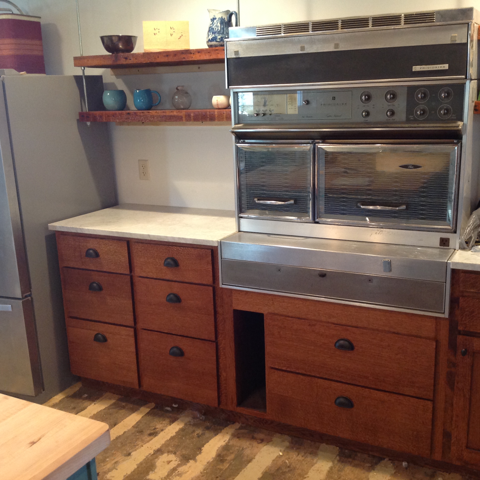 Cabinets and plank floor. Floor sanding and finishing is pending. The stove? It's called a "Flair" made by General Motors!
