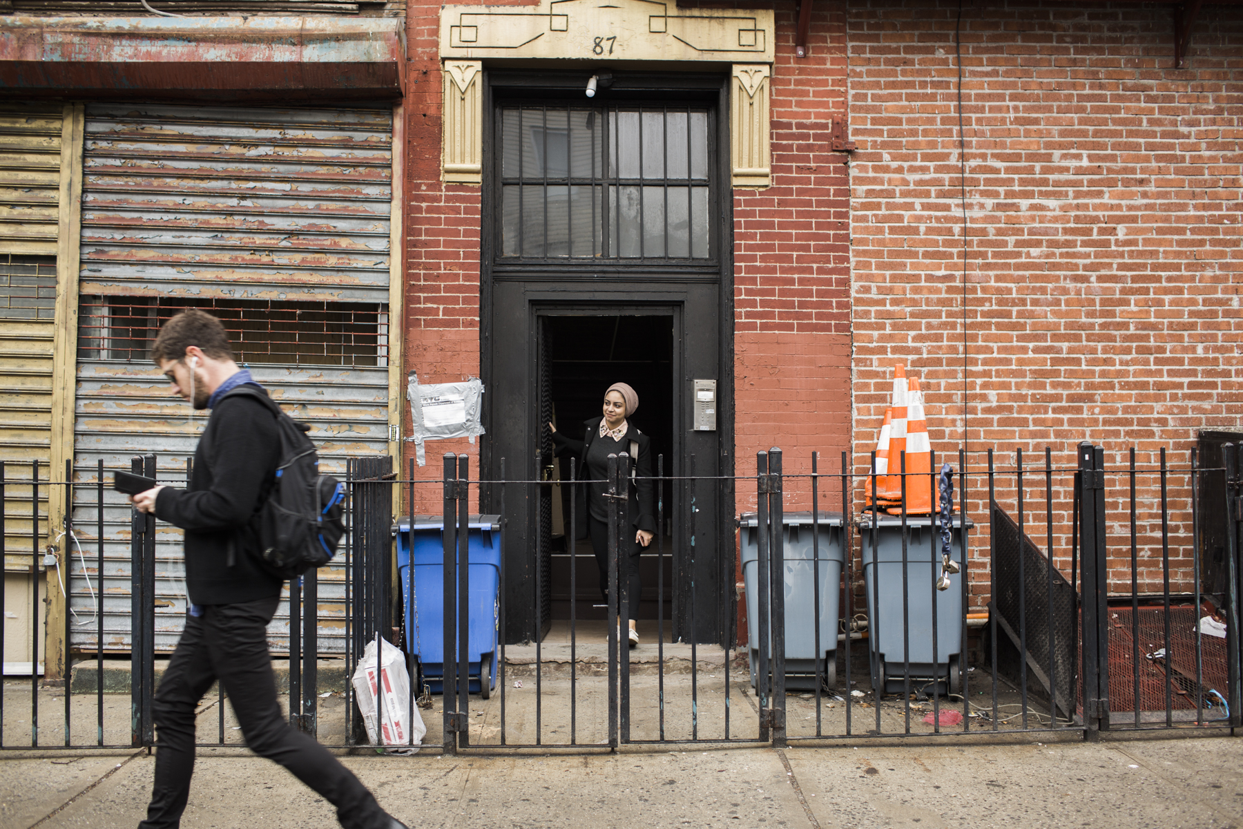 Sarah Al Saidi leaving her grandfather's home that she and her husband were temporarily living in after their apartment building caught fire. Al Saidi says that her head scarf was one of the few things she grabbed as she and her husband fled their apartment. 