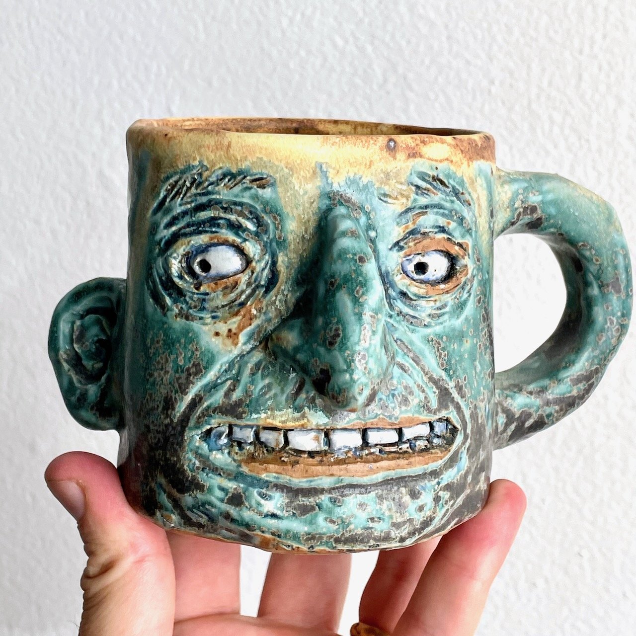 Green mug with an ear and a handle
3.5 x 6.5 x 4.5
2025
$