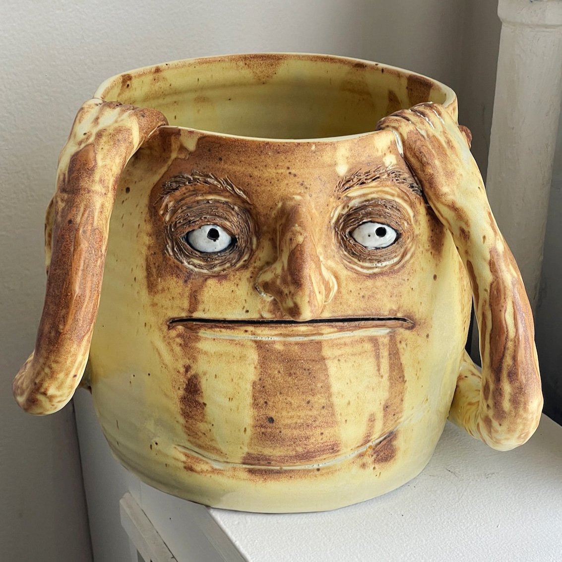 Big yellow planter holding his head.
9 x 8 x 10
2025
$