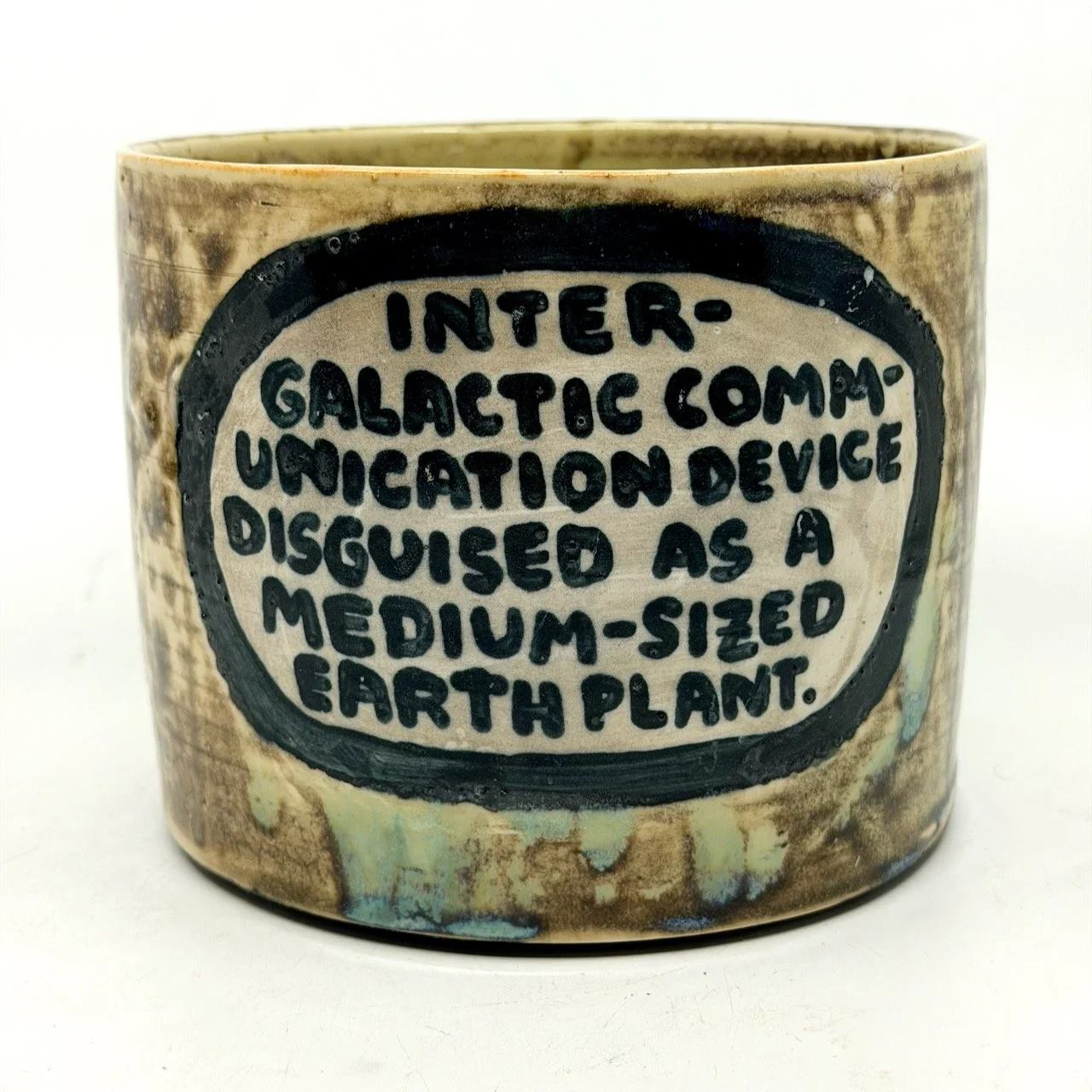 Intergalactic communication device disguised as a medium-sized earth plant // lots of text on the bottom  -- 6.5 inches wide.