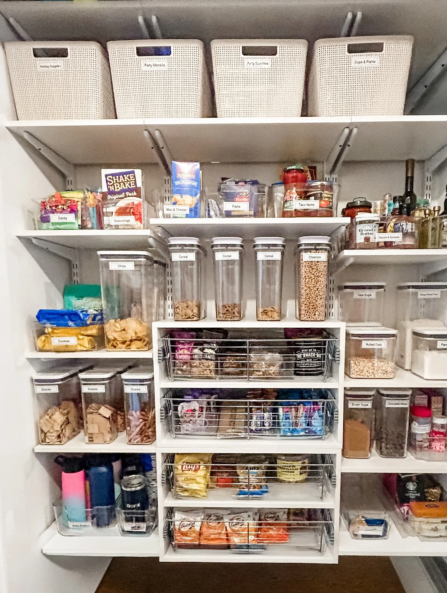 #makeovermonday pantry style! This recent pantry project got an overhaul with solid shelving (no more items falling through the wire) and pull outs for kids snacks. New doors, adjustable shelves and organizational products help sustain the new system