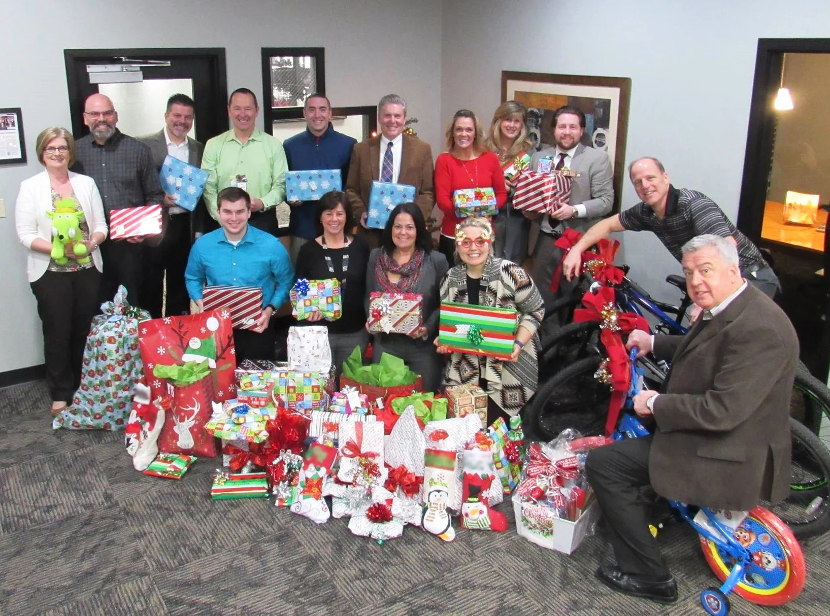 NAI Mid-Michigan/TMN Commercial professionals with holiday gifts for hosted family