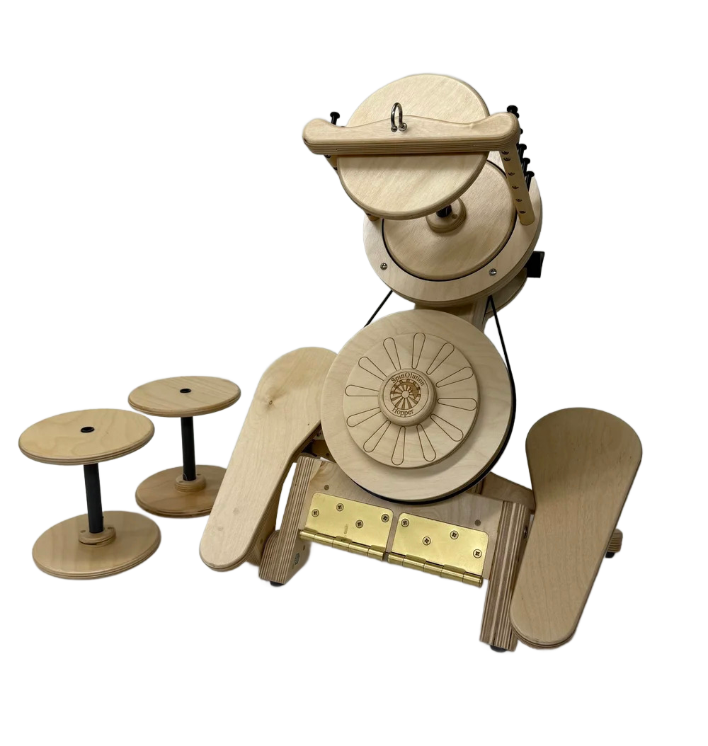 Wooden mechanical clock with rotating discs and two small stools beside it.