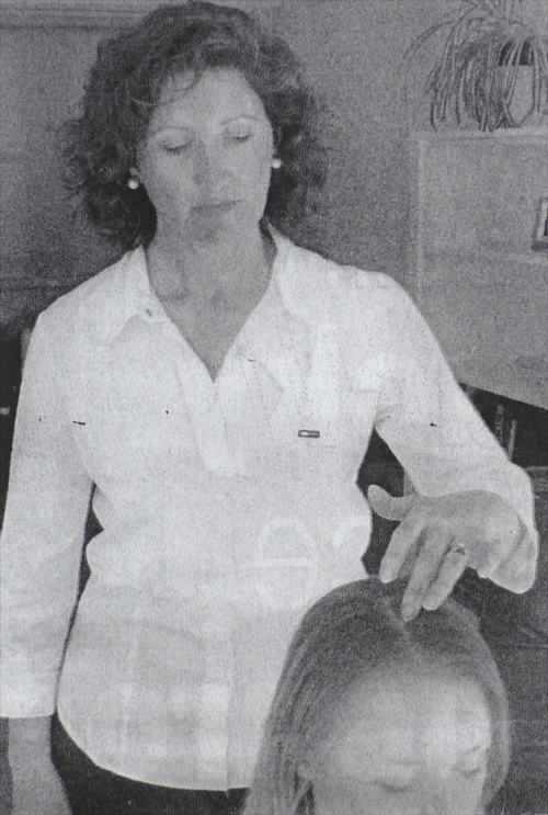 Margaret paying attention to the head in treatment.