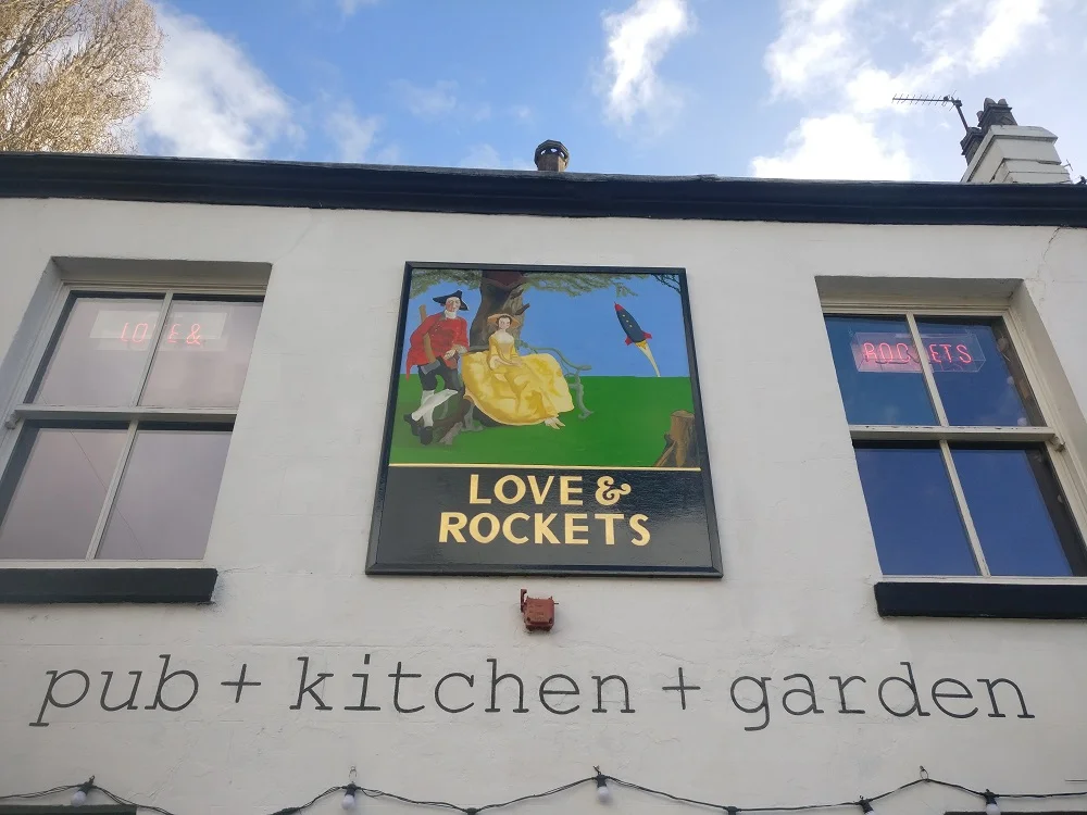 Hand painted pub style pictoral sign and wall lettering at Love & Rockets, Liverpool.