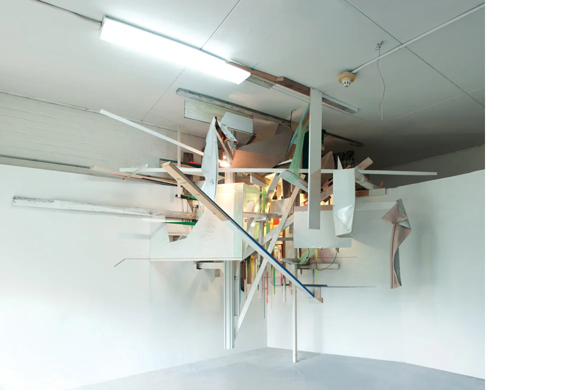 INTERSECTION site specific installation with wood, foam, cellophane, aluminum, acrylic paint, spray enamel, cardboard, compact fluorescent light bulbs, extension cords, and salvaged building materials, 130 x 176 x 116 inches, 2011