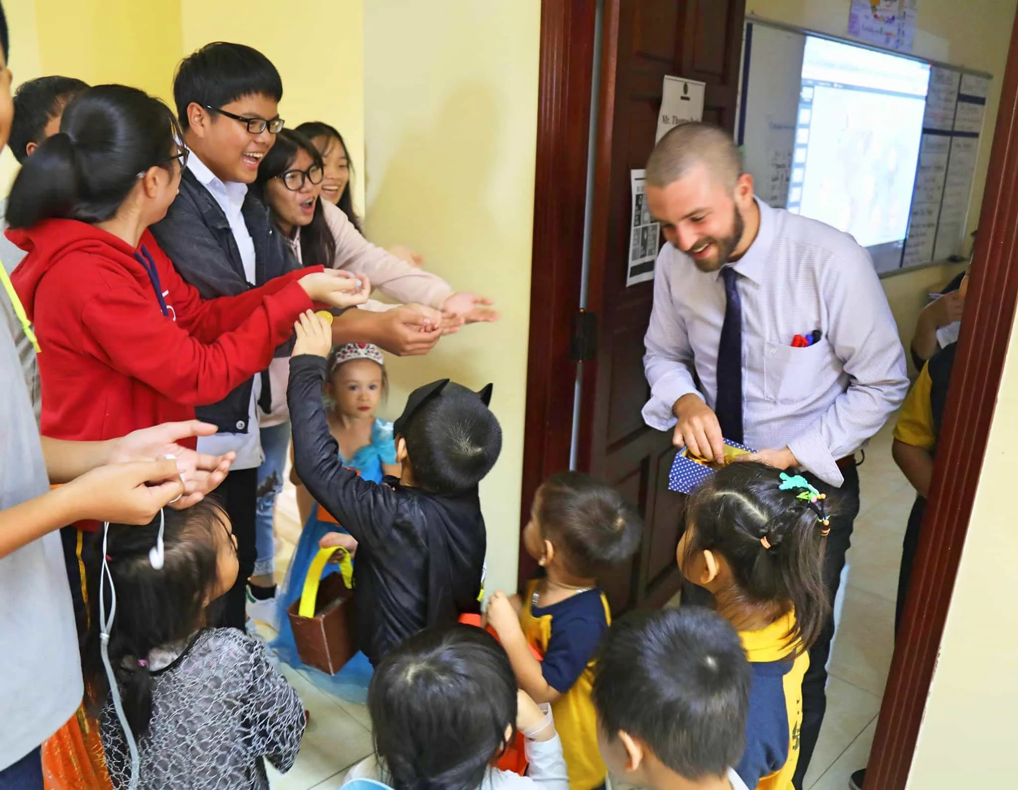 Handing out candy for Halloween while working at APU International School Da Nang, Vietnam