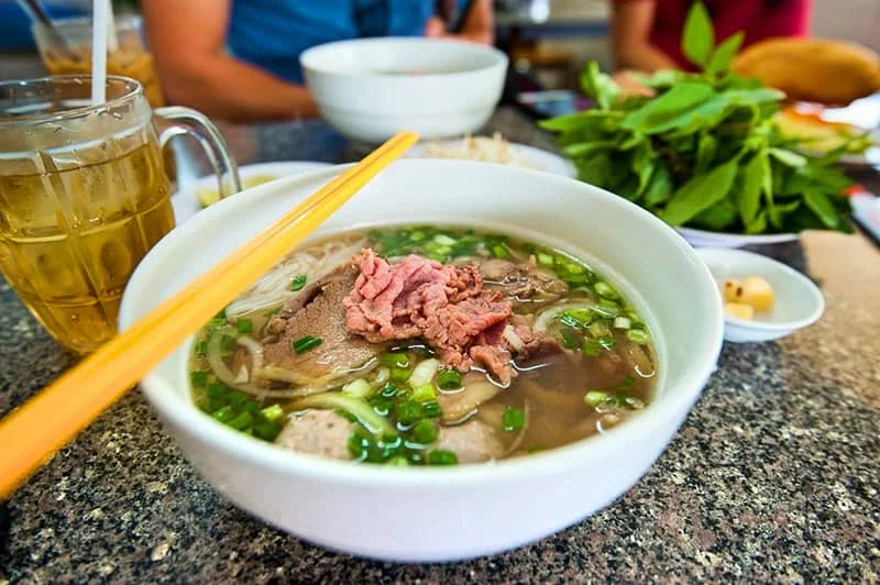 Pho - Cost $2 - $4 - Phở or pho is a Vietnamese noodle soup consisting of broth, rice noodles called bánh phở, a few herbs, and meat, primarily made with either beef or chicken.
