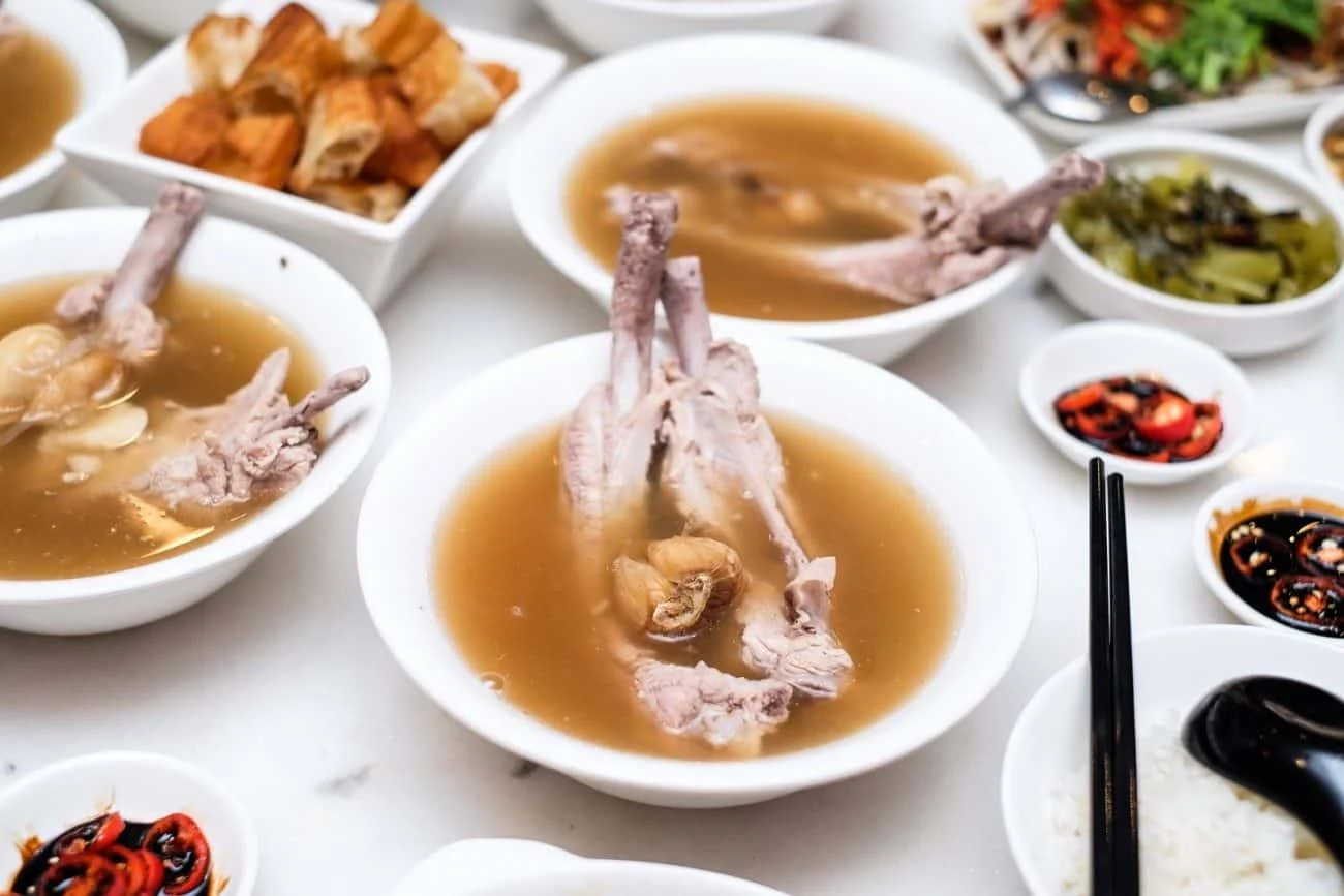 Bak Kut Teh - The name literally translates from hokkien (dialect) as "meat bone tea", and at its simplest, consists of meaty pork ribs simmered in a complex broth of herbs and spices (including star anise, cinnamon, cloves, fennel seeds and garlic) for hours. Despite its name, there is in fact no tea in the dish itself; the name refers to a strong oolong Chinese tea which is usually served alongside the soup in the belief that it dilutes or dissolves the copious amount of fat consumed in this pork-laden dish.