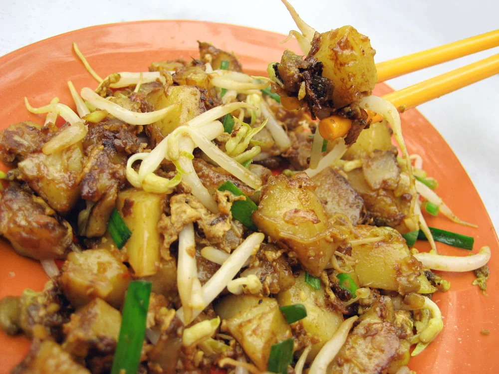 Carrot Cake (Chai Tow Kway) - Also known as "fried carrot cake" or simply "carrot cake" in Southeast Asian countries. It is a much-loved local comfort food in the region, and can be consumed at various times of the day. It is made with radish cake (steamed rice flour, water, and shredded white daikon), which is then stir-fried with eggs, preserved radish, and other seasonings.