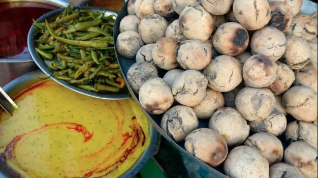 Dal Baati Churma - A mouthwatering Rajasthani favorite - this dish is comprised of dal (lentils) and baati (hard wheat rolls). Dip, soak, or smother the baati and enjoy!