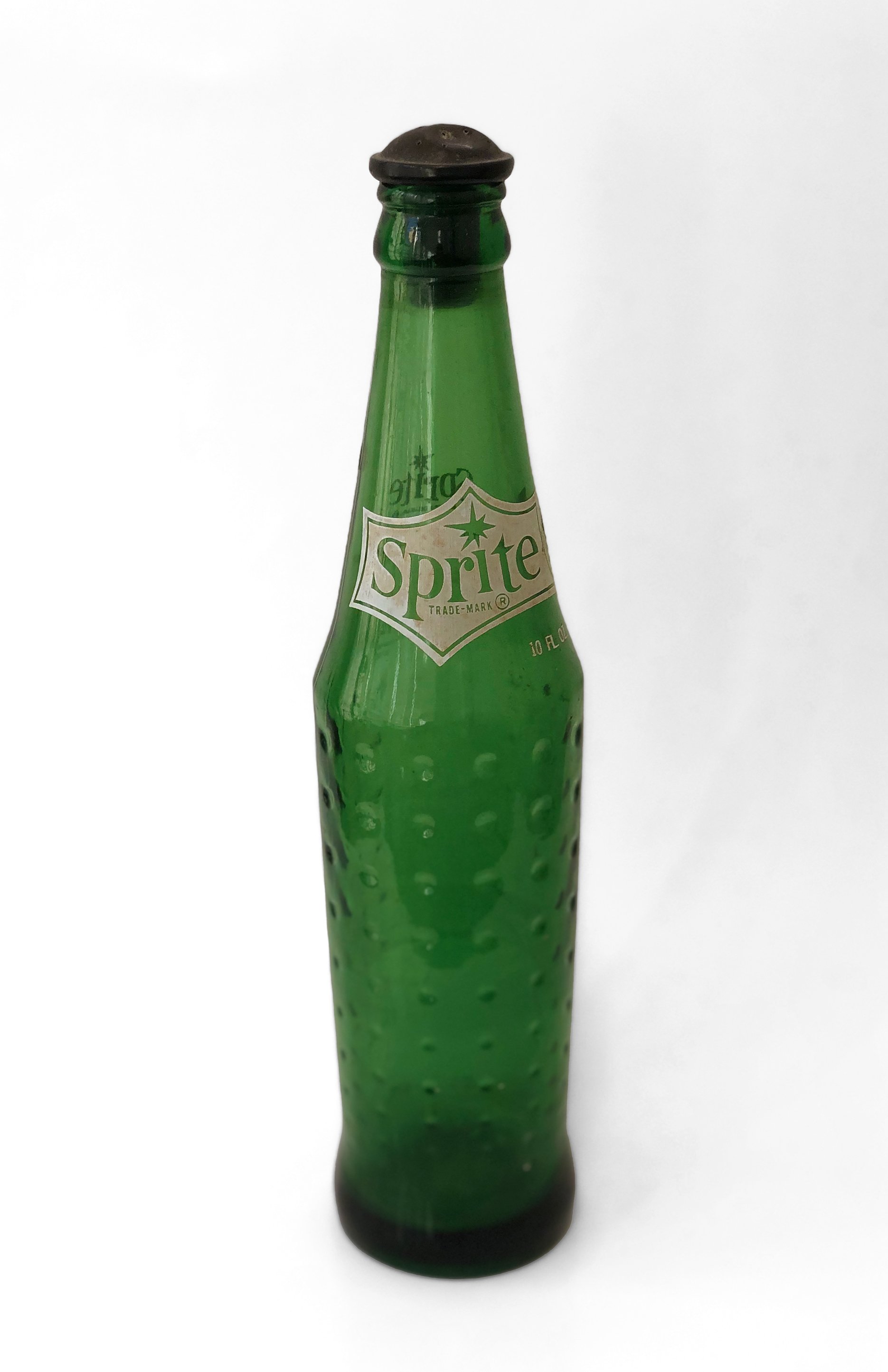    The Sprite Bottle, an icon from bygone days before the steam iron, before 'wash and wear' clothes. It brings back memories of the ironing board and soap operas on the TV.   ~ Carol Ivey&nbsp;  