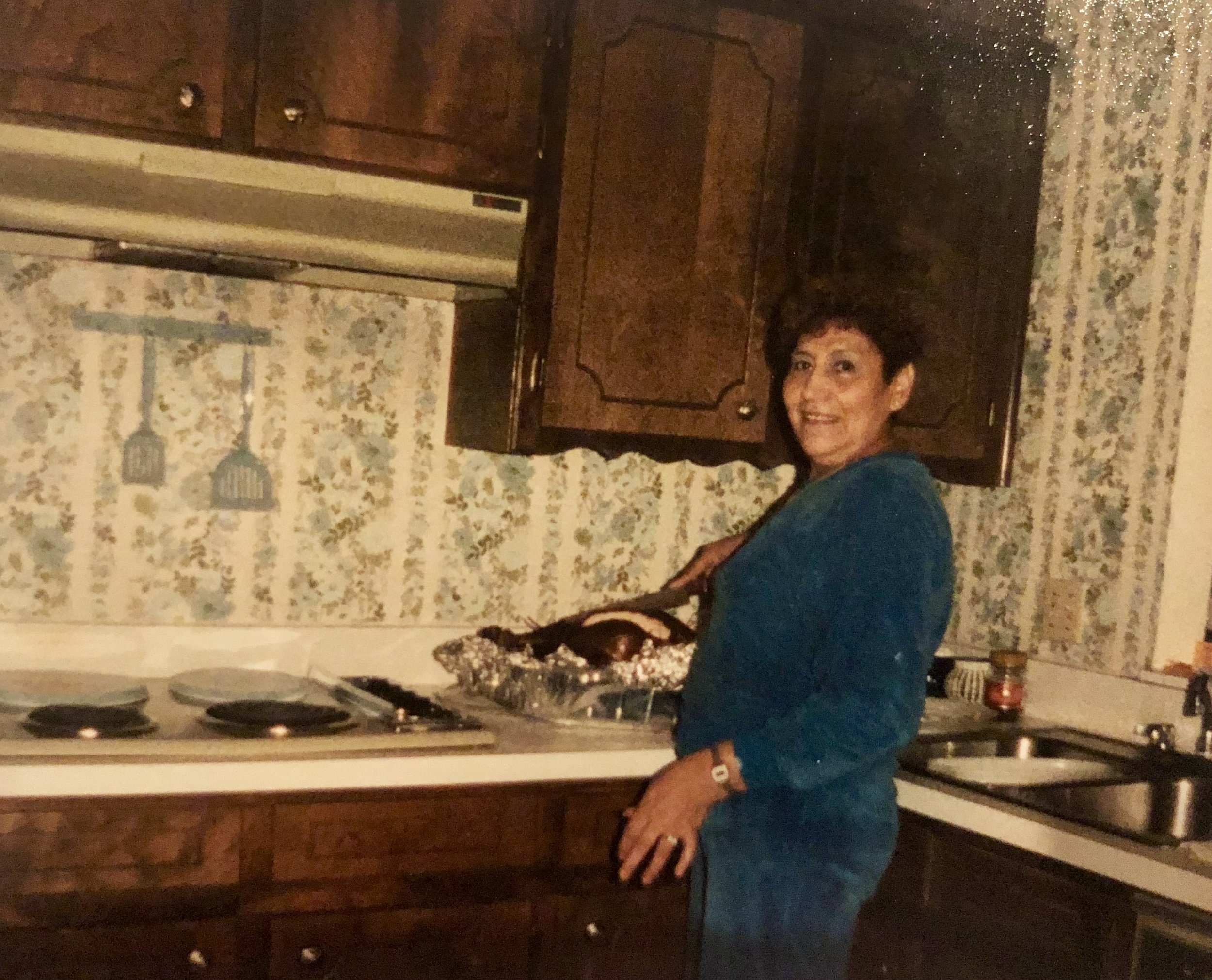    This is an old Photo of my Grandma Julia who was the matriarch of my family. I love looking at this image of her standing healthy, happy and proud of the thanksgiving meal she made. She wasn’t much for words, and these days, she doesn’t speak at a