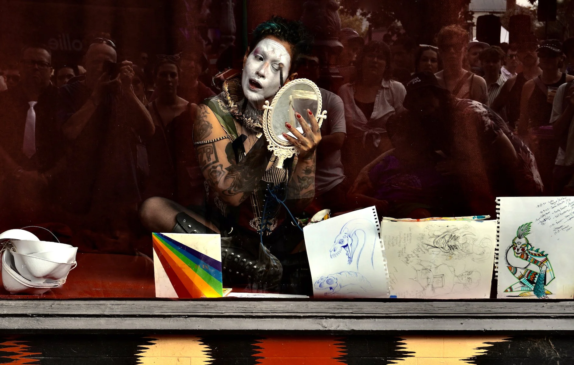  Applying makeup in a Gertrude street shop window. 