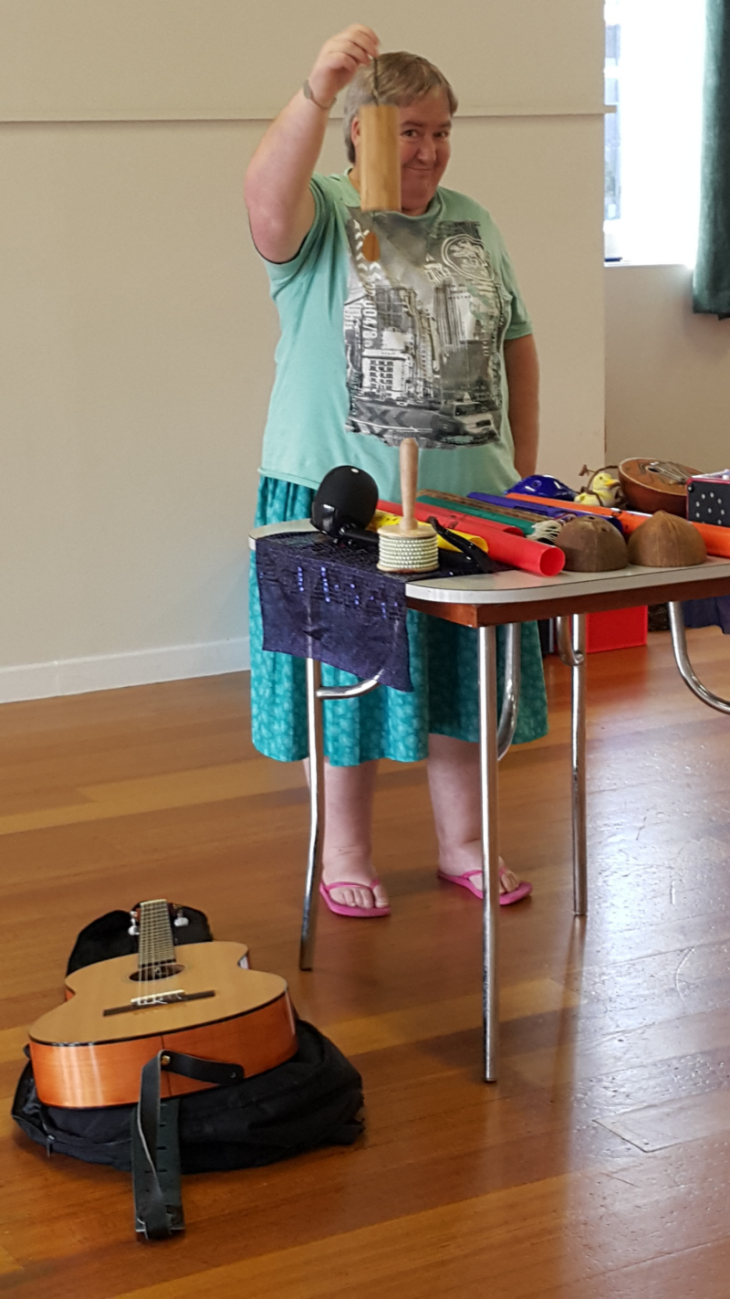 Karin playing music, one of her favourite things to do at Aplha Omega Playback Theatre Company