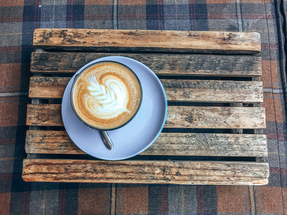 A-latte-served-on-a-wooden-tray-at-The-Milkman-Edinburgh-Scotland.jpg