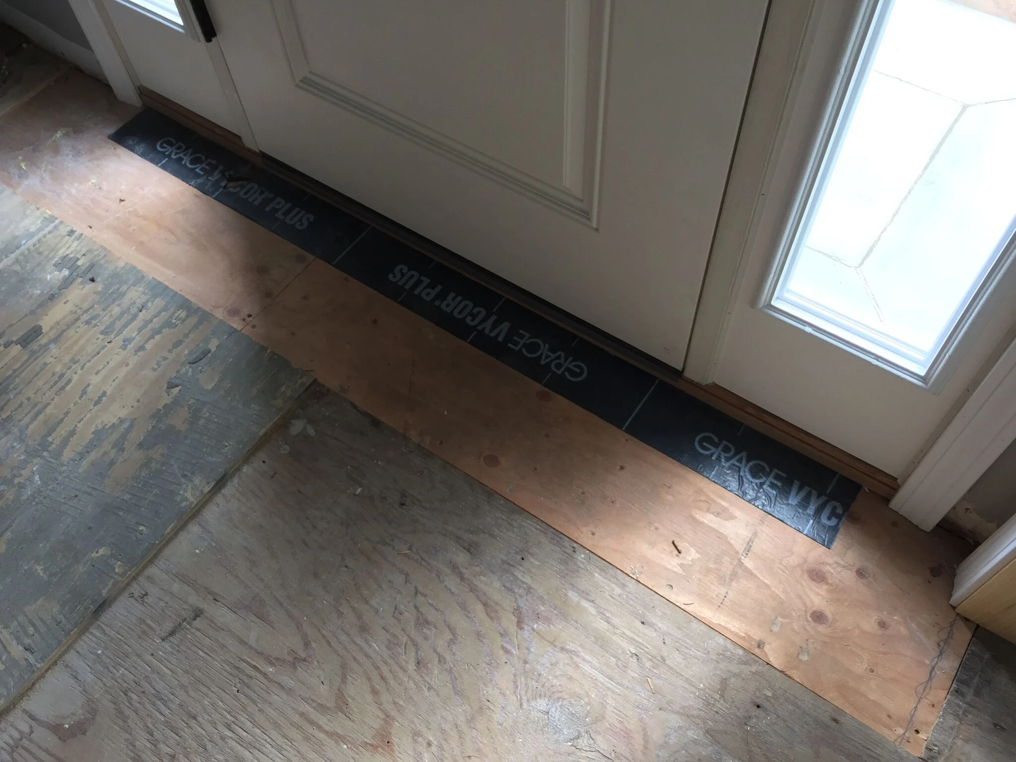 New plywood flooring and flashing tape to protect area by door opening