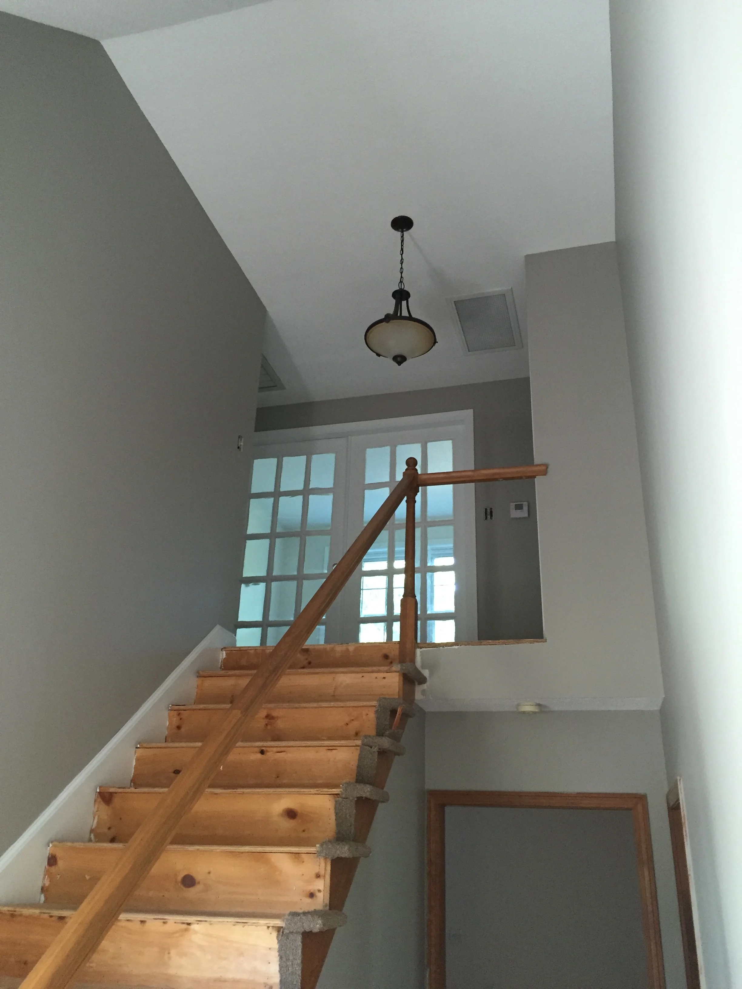 STAIRWELL - AFTER PAINT - I wanted something a little more dramatic for the foyer so I went with a darker warm gray, so that it felt richer but still welcoming. I am able to envision the 'end result' in my head so these colors will work perfectly!