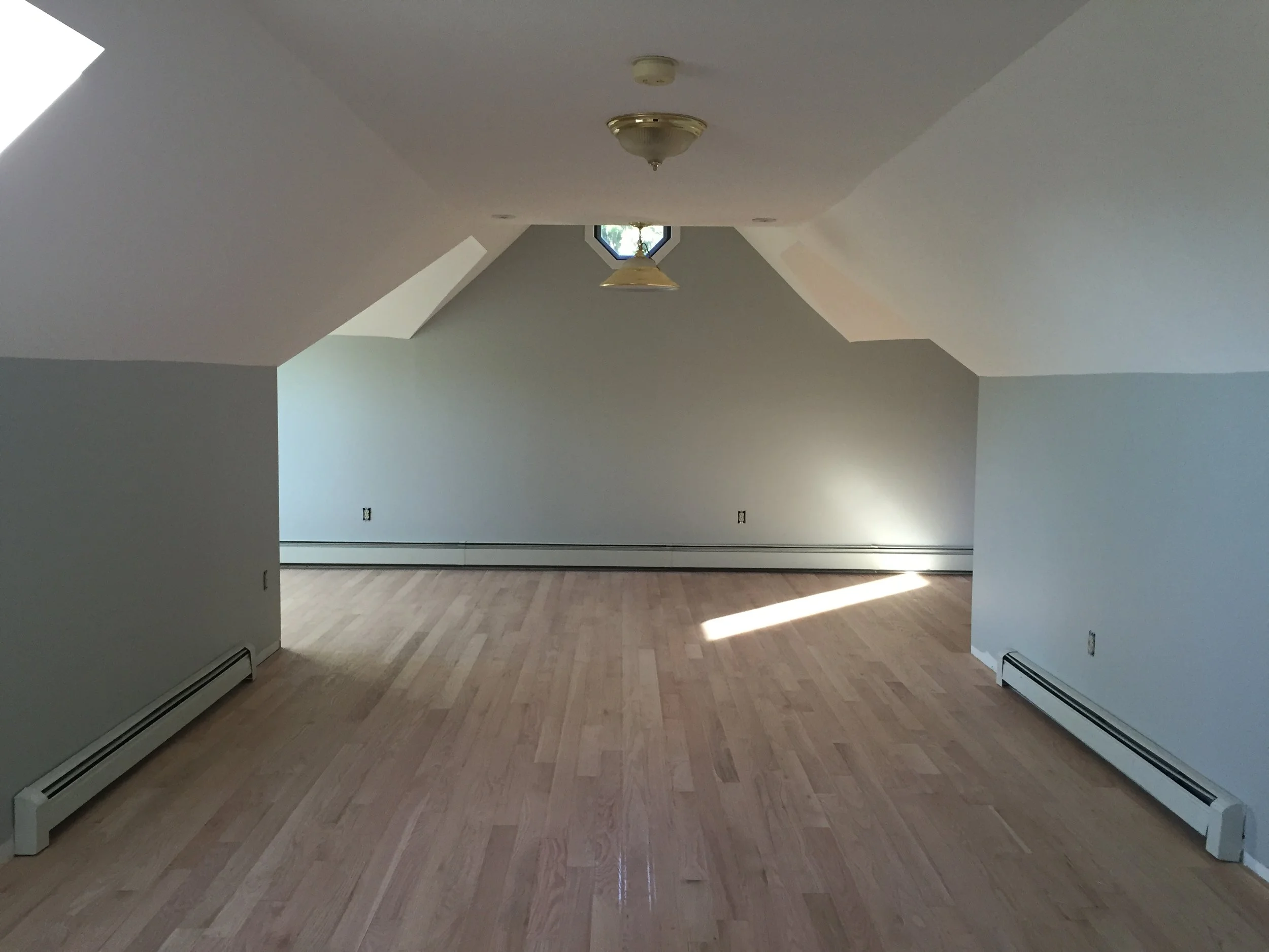 AFTER - TV room with new red oak flooring installed (unstained)