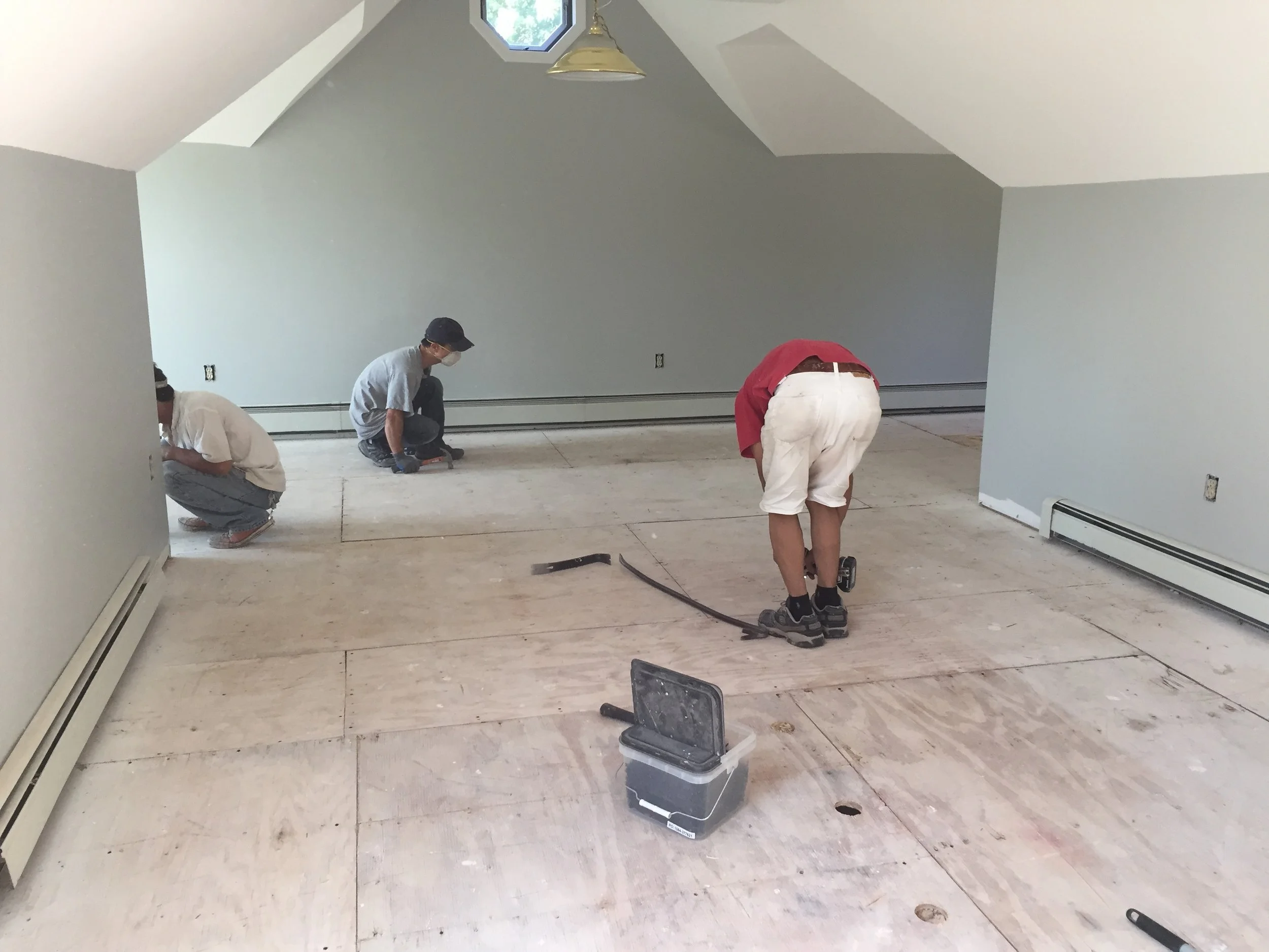 PROGRESS - TV room with carpeting removed + screwing the subfloor to the floor joists to eliminate squeaking