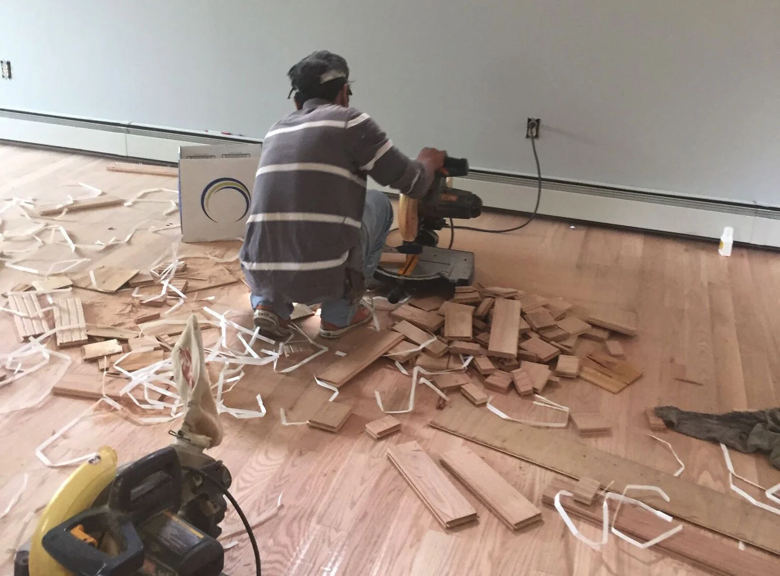 PROGRESS - TV room with new red oak flooring being cut down to fill in the gaps 