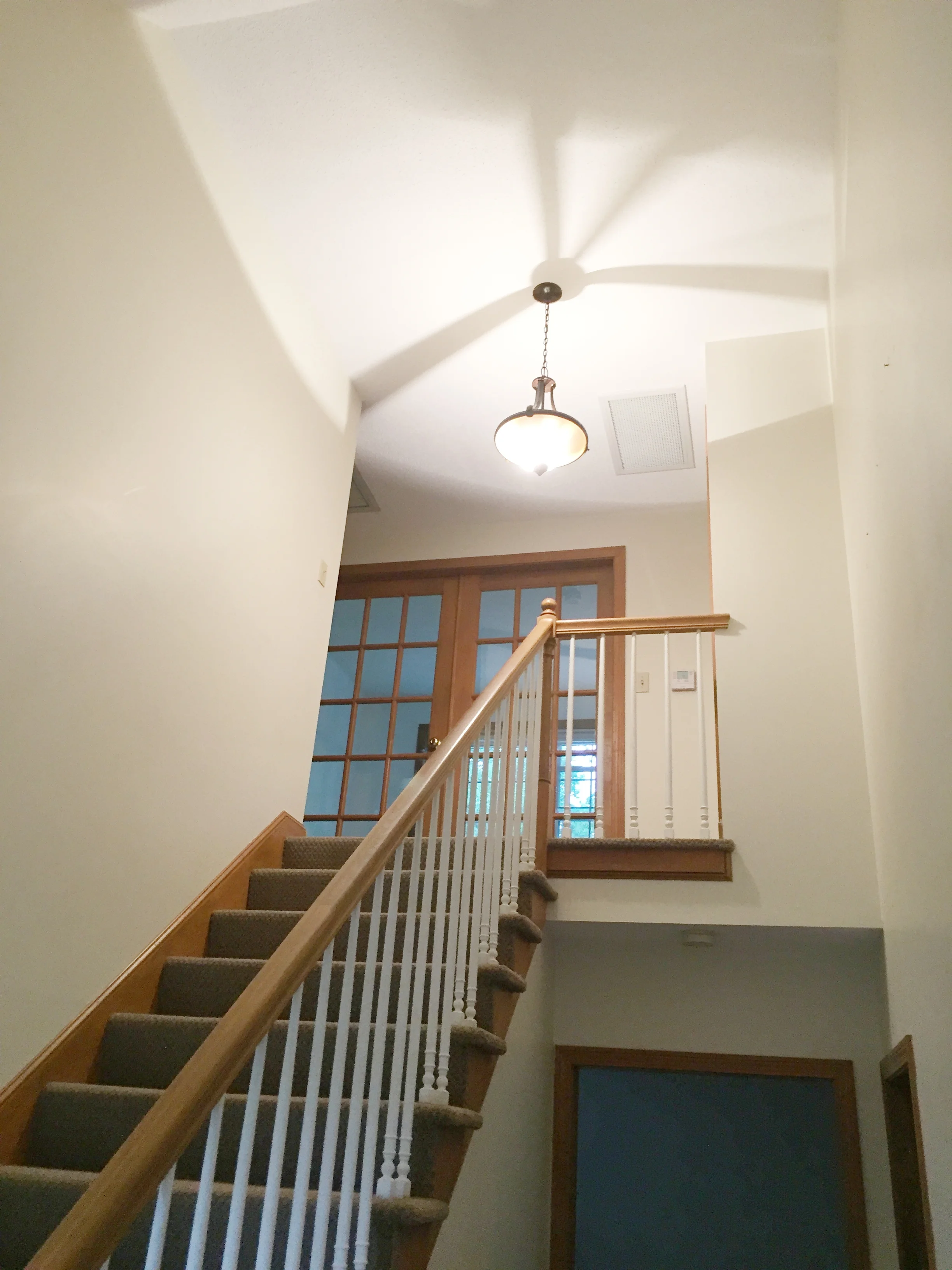 BEFORE - Entry Stairs with carpeting and light oak railing