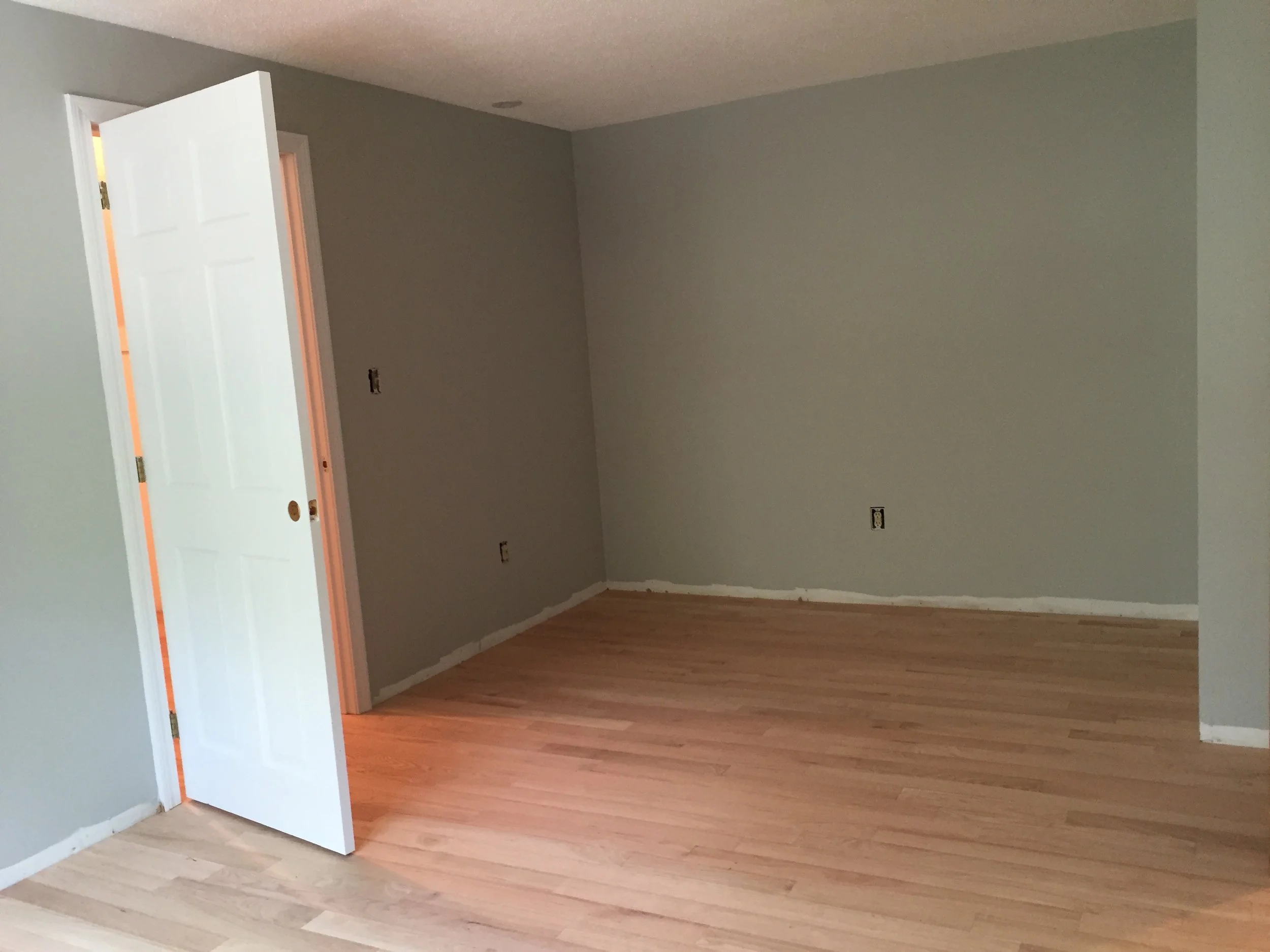 AFTER - Bedroom with new red oak flooring installed (unstained)
