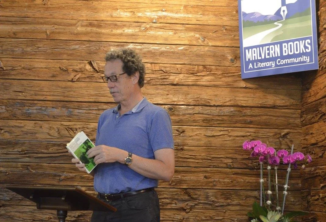 Joe Bratcher, owner of Malvern Books, reading at the Poetry Karaoke event this past April. 