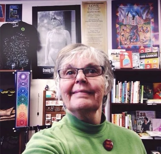 Susan Post among the many baubles, treasures, and magic housed at Bookwoman.