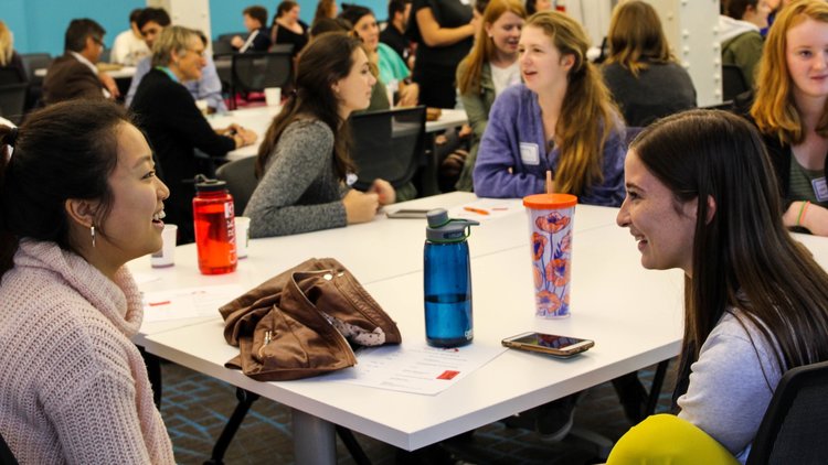 students talking with each other during a class activity