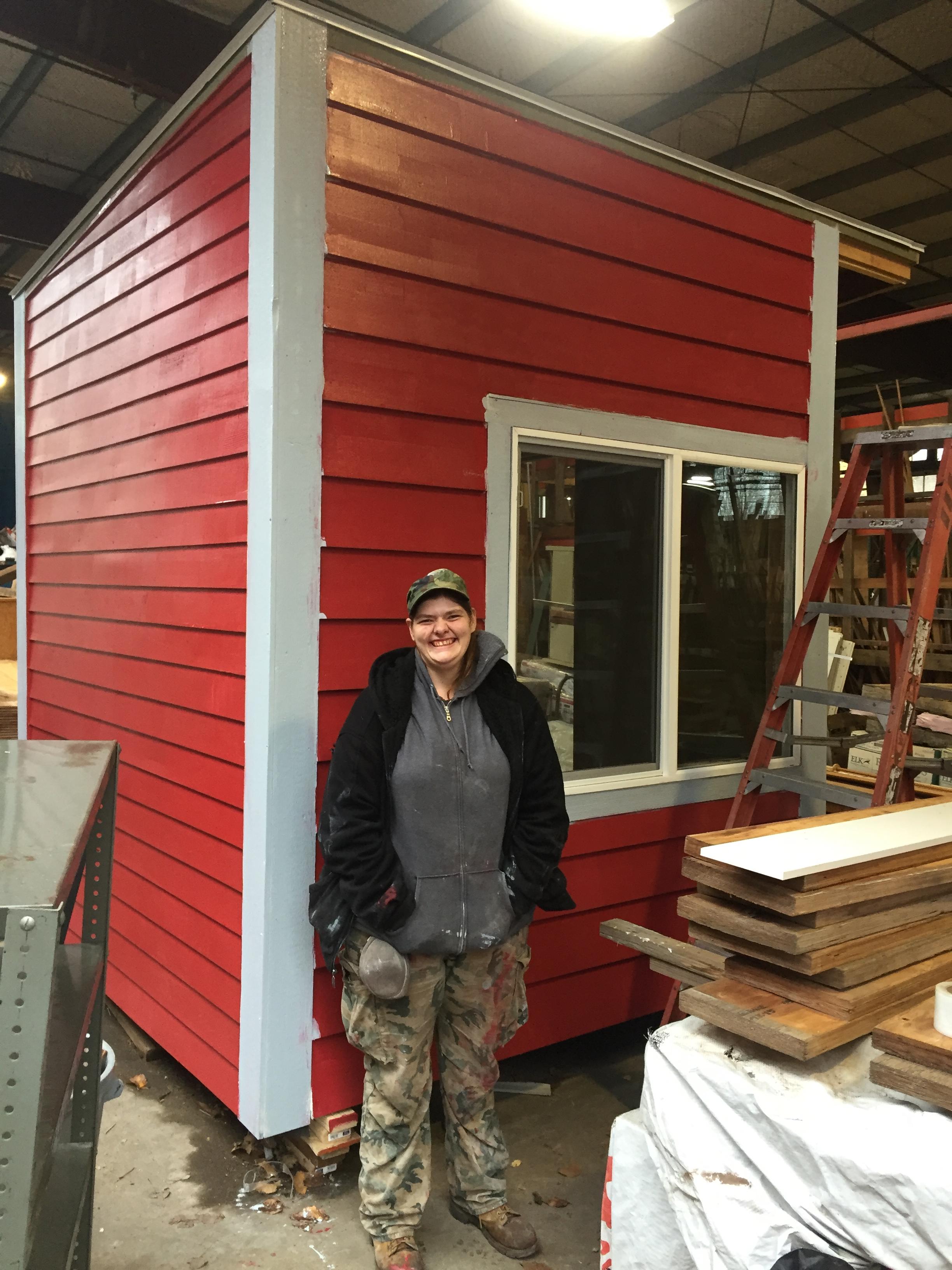 Loki with her tiny house built in the RBC lumberyard