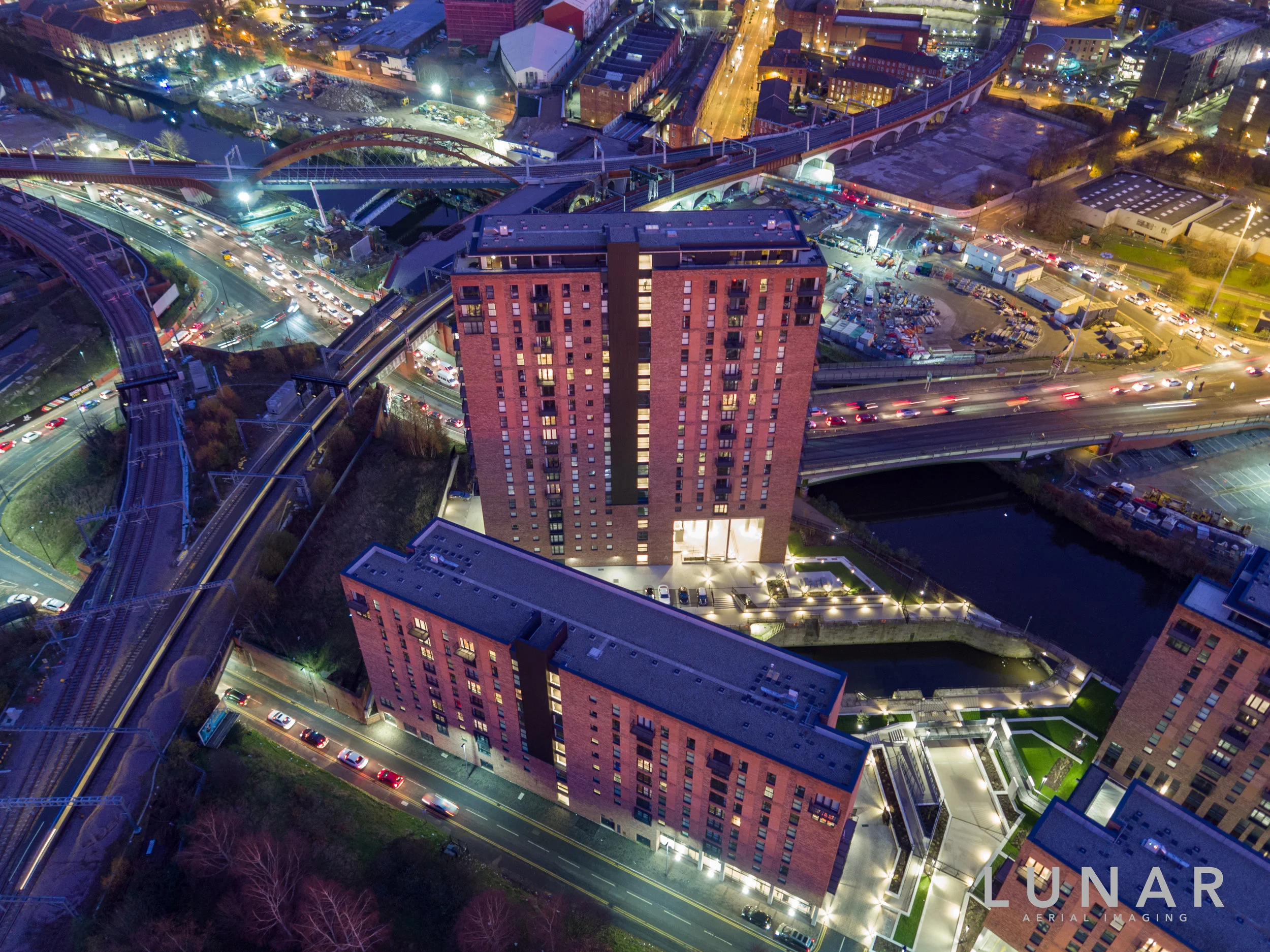 Aerial view of property development at night in Salford