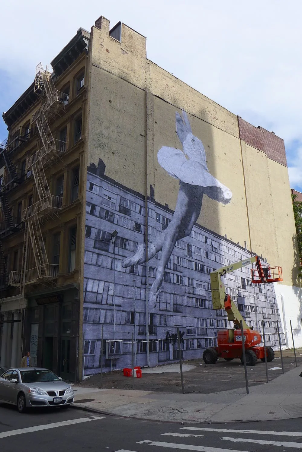 In this image, as the progression of the mural nears its completion we see that there are posts in place for the fence.