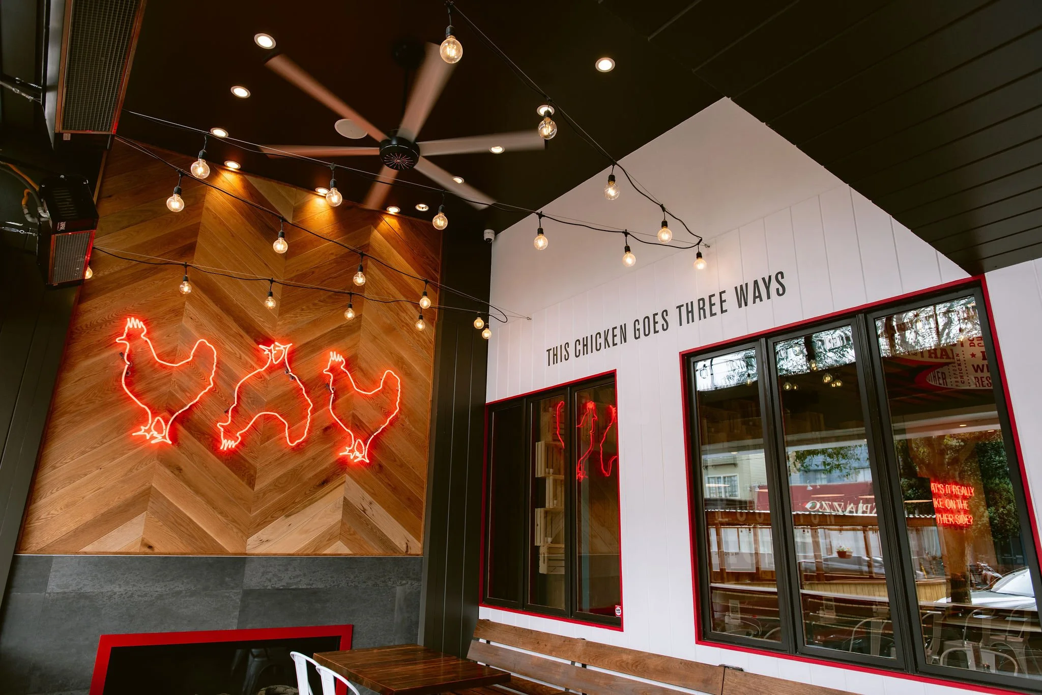 Custom chevron wood fireplace surround at Proposition Chicken by Cookline Millwork Shop