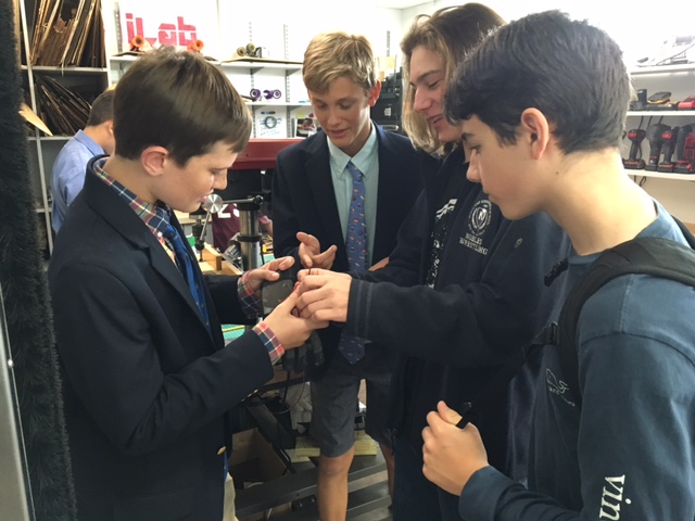 Students collaborating on servo glove design