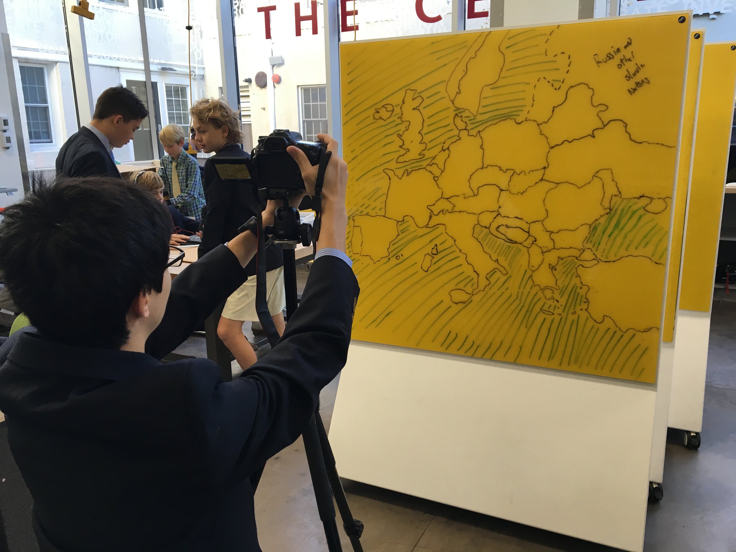 This student prepares still shots for his TedTalk on the European refugee crisis