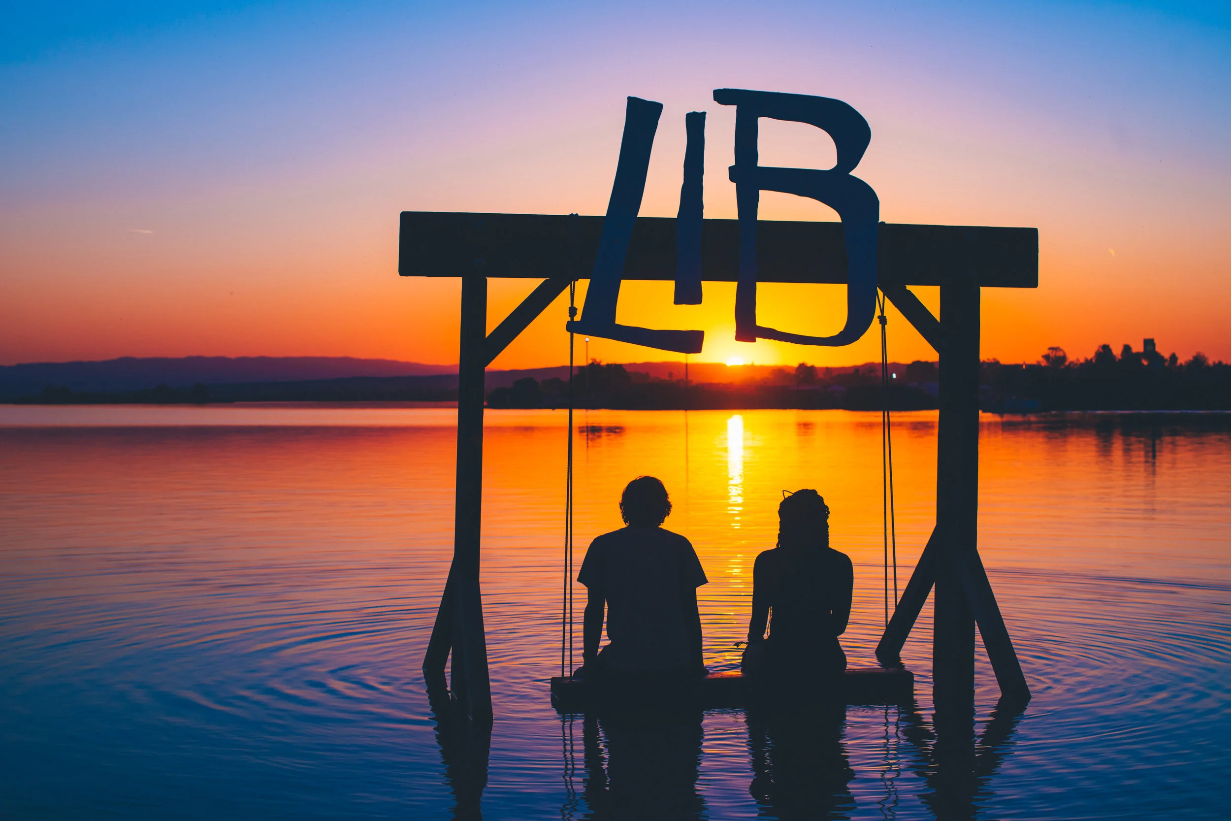 Two people sit for quiet reflection on an aquatic installation 📷: Juliana Bernstein